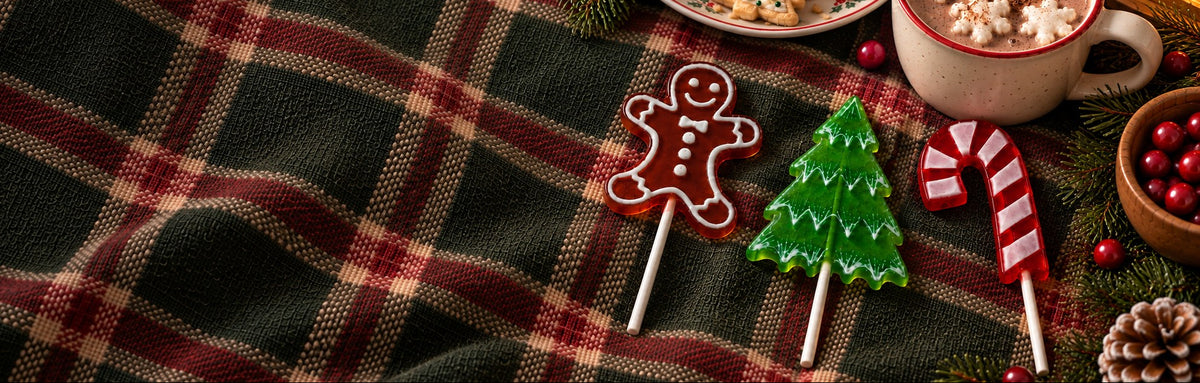Christmas lollipops with cocoa on a plaid blanket